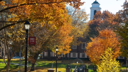 fall trees in front of the Old Queens building