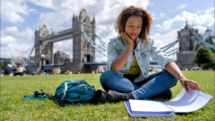 Student studying in front of Tower Bridge, England