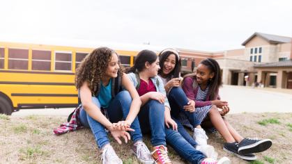 Middle School Students in front of bus