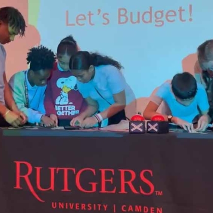 Photo of students at a Rutgers table