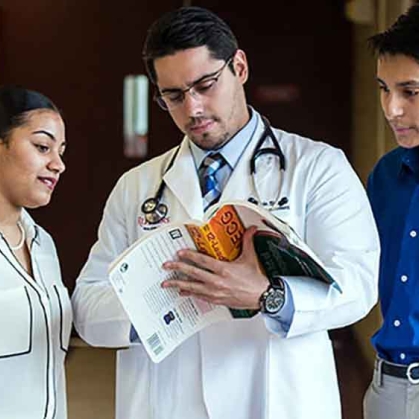photo of medical instructor standing with two students
