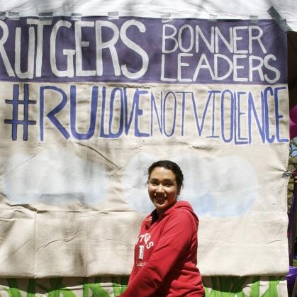 Student stands in front of Rutgers Bonner Leaders sign.