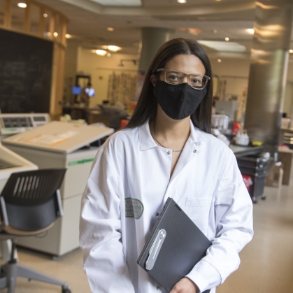Rutgers student poses in lab.