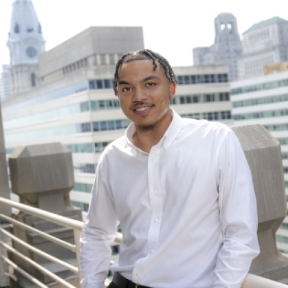Rutgers student Quincy Wright poses on rooftop terrace