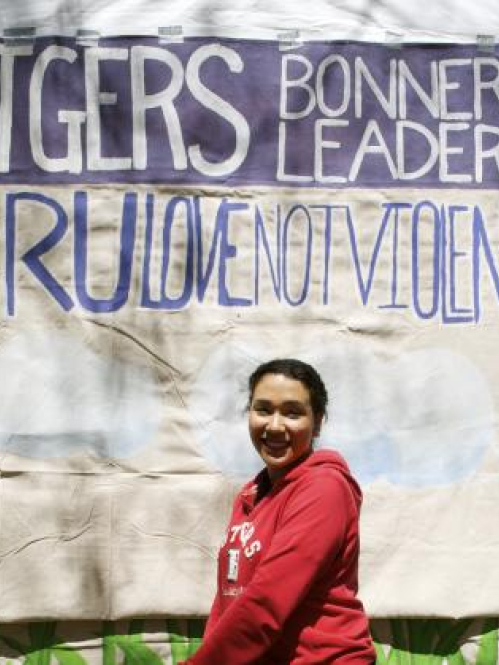 Student stands in front of Rutgers Bonner Leaders sign.