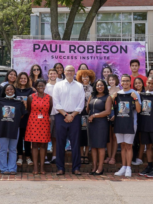 Large group of students pose with President Jonathan Holloway and Anna Branch during Paul Robeson Success Institute.