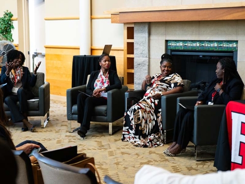 photo of women seated and talking in a room
